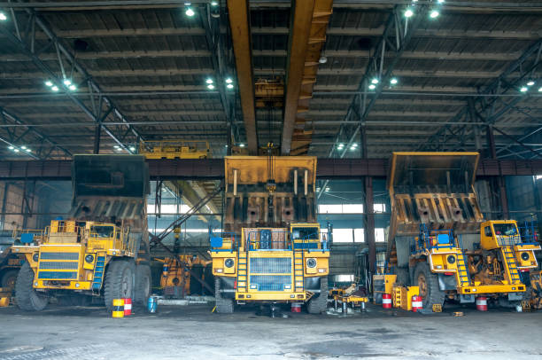 heavy yellow open cast mine dump trucks at repair station heavy yellow open cast mine dump trucks at repair station