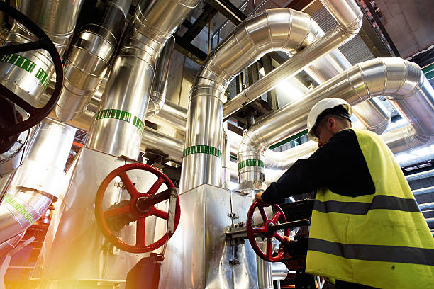 modern factory worker turning valve modern factory worker turning valve